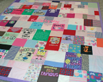 quilt with baby clothes