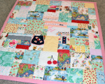 quilt with baby clothes
