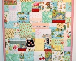 quilt with baby clothes