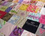 quilt with baby clothes