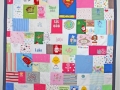 quilt made out of baby clothes