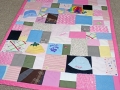 quilt made out of baby clothes