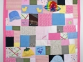 quilt made out of baby clothes