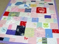 quilt made out of baby clothes