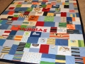 quilt with baby clothes