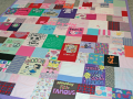 quilt with baby clothes