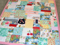 quilt with baby clothes