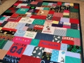 quilt with baby clothes