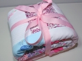 Cute baby clothes quilt in ribbon.