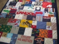 quilt with baby clothes