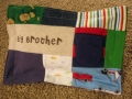 quilt with baby clothes