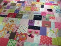 quilt with baby clothes