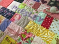 quilt with baby clothes