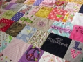 quilt with baby clothes