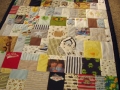quilt with baby clothes