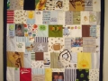quilt with baby clothes